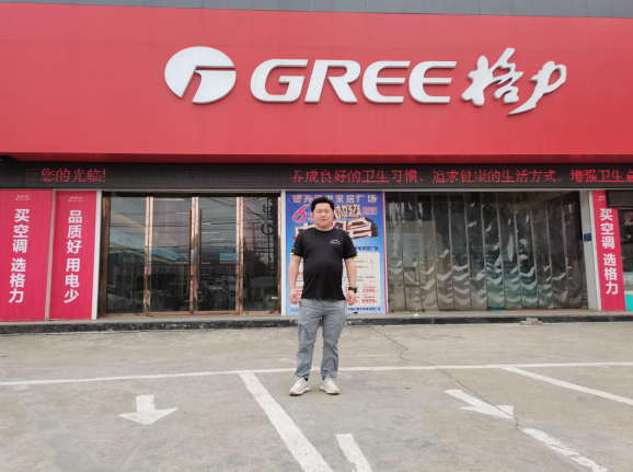 (图为湖北经销商王先生与格力专卖店的合影)